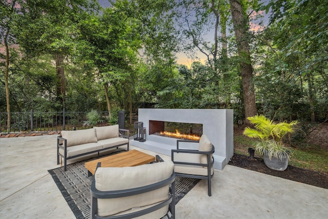 2411 Oakbank Dr, Houston, TX 77339 - patio terrace at dusk with a patio area and an outdoor living space with a fireplace