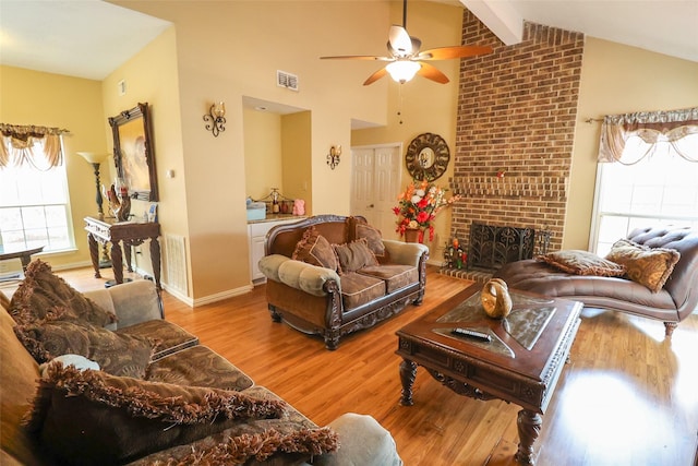 13555 Portobello Dr, Houston, TX 77083 - living room featuring wood finished floors, ceiling fan, beam ceiling, high vaulted ceiling, and a fireplace