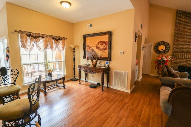 13555 Portobello Dr, Houston, TX 77083 - living area with wood finished floors, baseboards, and a brick fireplace
