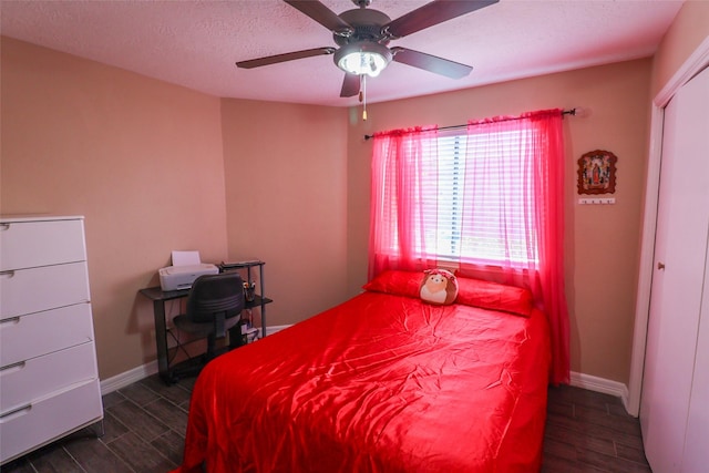 13555 Portobello Dr, Houston, TX 77083 - bedroom featuring wood finish floors, baseboards, ceiling fan, and a textured ceiling