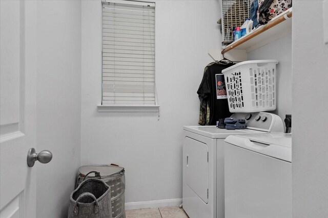 8731 Majesticbrook Dr, Houston, TX 77095 - washroom featuring washer and clothes dryer, light tile patterned flooring, and baseboards