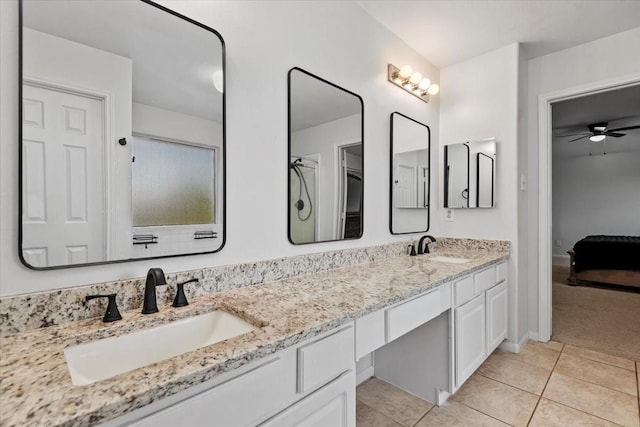 8731 Majesticbrook Dr, Houston, TX 77095 - full bathroom with ensuite bathroom, double vanity, tile patterned floors, ceiling fan, and a shower