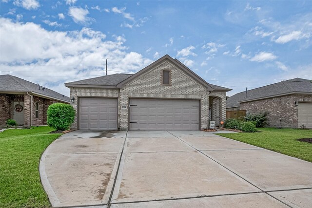 1214 Red Hills Dr, Rosharon, TX 77583 - view of front facade with brick siding, an attached garage, driveway, and a front lawn