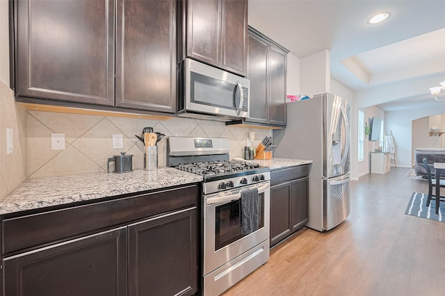 1214 Red Hills Dr, Rosharon, TX 77583 - kitchen featuring stainless steel appliances, dark brown cabinets, light wood-style flooring, baseboards, and recessed lighting