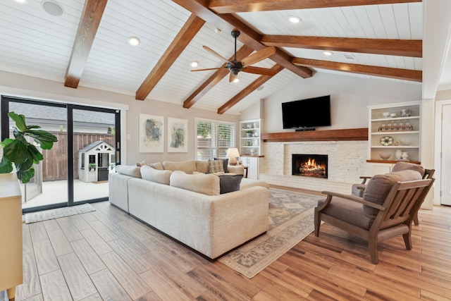 2502 Briarbrook Dr, Houston, TX 77042 - living room with a lit fireplace, light wood finished floors, a ceiling fan, recessed lighting, and wooden ceiling