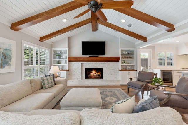 2502 Briarbrook Dr, Houston, TX 77042 - living room featuring wine cooler, wood finished floors, a warm lit fireplace, healthy amount of natural light, and recessed lighting