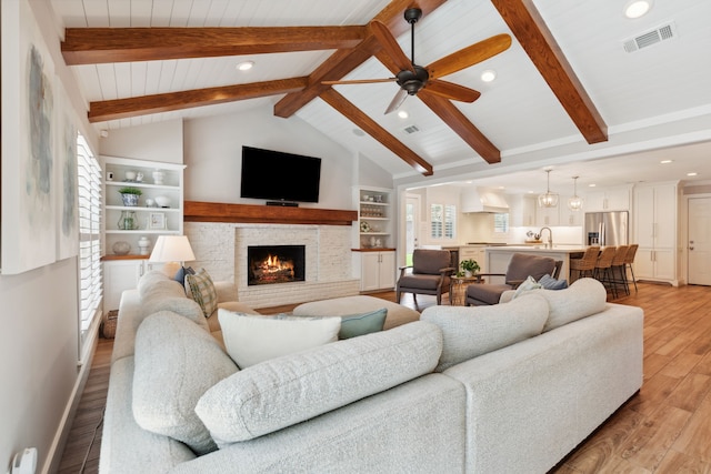 2502 Briarbrook Dr, Houston, TX 77042 - living room featuring light wood finished floors, recessed lighting, a fireplace, a ceiling fan, and baseboards