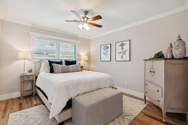 2502 Briarbrook Dr, Houston, TX 77042 - bedroom with ornamental molding, baseboards, light wood-style flooring, and a ceiling fan
