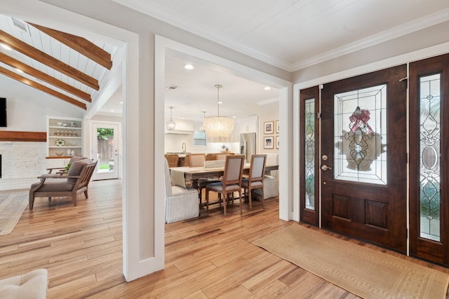 2502 Briarbrook Dr, Houston, TX 77042 - entrance foyer with light wood-style flooring, a fireplace, crown molding, baseboards, and a chandelier