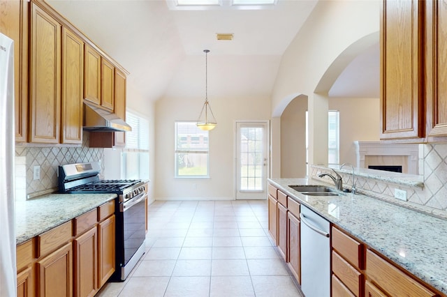 3606 Kilgore Ct, Manvel, TX 77578 - kitchen with stainless steel appliances, under cabinet range hood, a sink, backsplash, and lofted ceiling