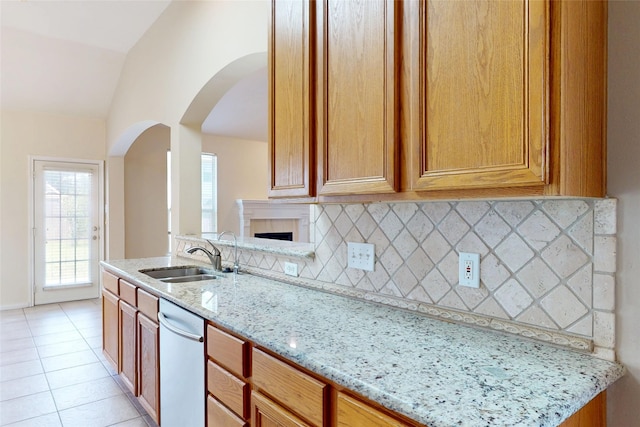 3606 Kilgore Ct, Manvel, TX 77578 - kitchen with a sink, lofted ceiling, tasteful backsplash, light stone counters, and arched walkways