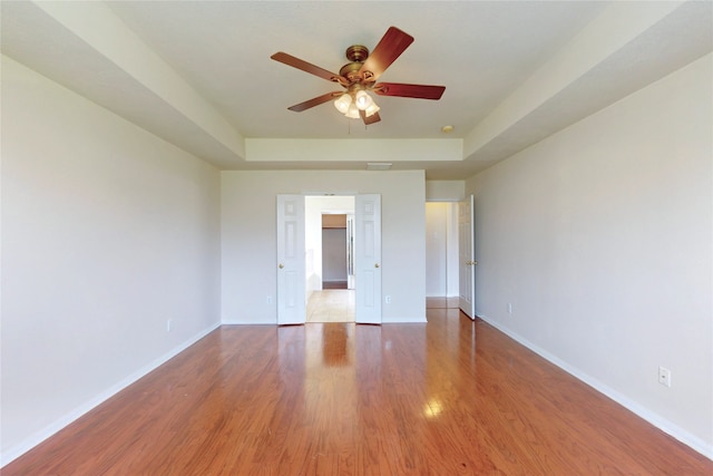 3606 Kilgore Ct, Manvel, TX 77578 - spare room featuring wood finished floors, ceiling fan, baseboards, and a raised ceiling