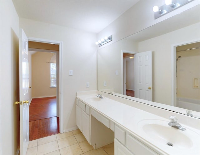 3606 Kilgore Ct, Manvel, TX 77578 - bathroom featuring double vanity, tile patterned floors, baseboards, and shower / tub combination