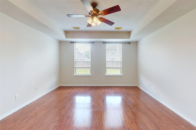 3606 Kilgore Ct, Manvel, TX 77578 - unfurnished room featuring a ceiling fan, baseboards, wood finished floors, and a raised ceiling