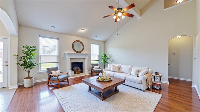 3606 Kilgore Ct, Manvel, TX 77578 - living room with arched walkways, wood finished floors, a ceiling fan, a fireplace, and high vaulted ceiling