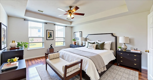 3606 Kilgore Ct, Manvel, TX 77578 - bedroom with a tray ceiling, wood finished floors, baseboards, and ceiling fan