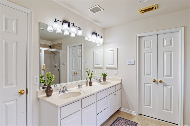 3606 Kilgore Ct, Manvel, TX 77578 - bathroom with tile patterned flooring, double vanity, a stall shower, and baseboards