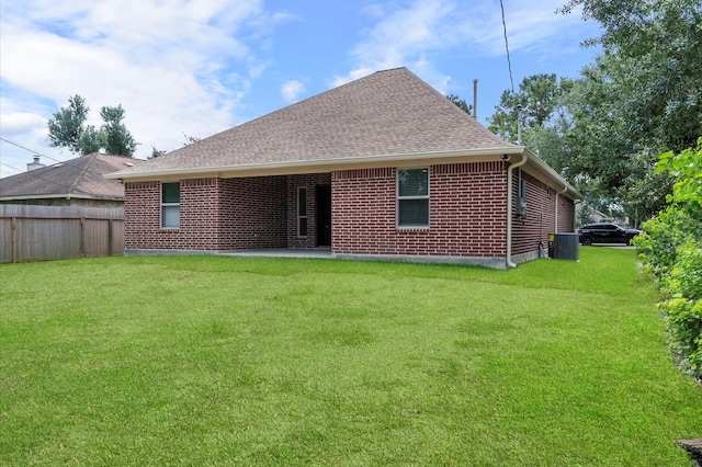 8423 Holiday Ln, Houston, TX 77075 - back of house featuring a shingled roof, central air condition unit, brick siding, and a patio