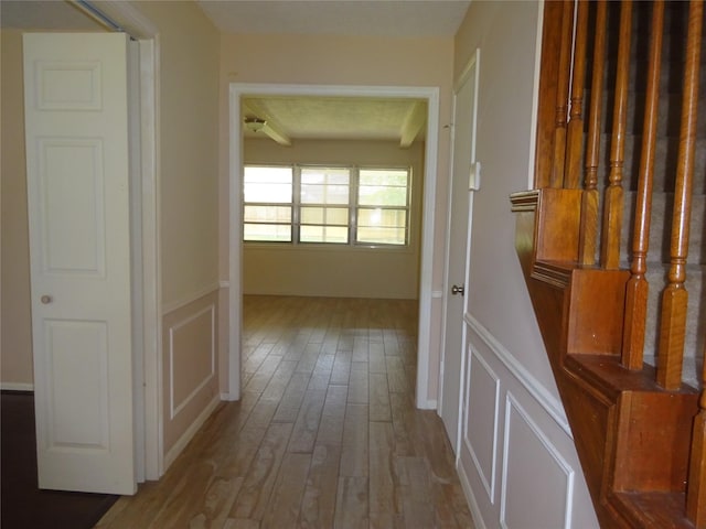 4810 Theall Rd, Houston, TX 77066 - corridor with a decorative wall, wood finished floors, and a wainscoted wall