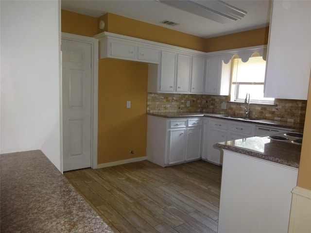 4810 Theall Rd, Houston, TX 77066 - kitchen featuring a sink, white cabinetry, and tasteful backsplash