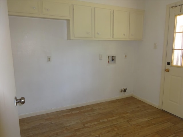 4810 Theall Rd, Houston, TX 77066 - laundry room featuring cabinet space, light wood-type flooring, hookup for a washing machine, and baseboards