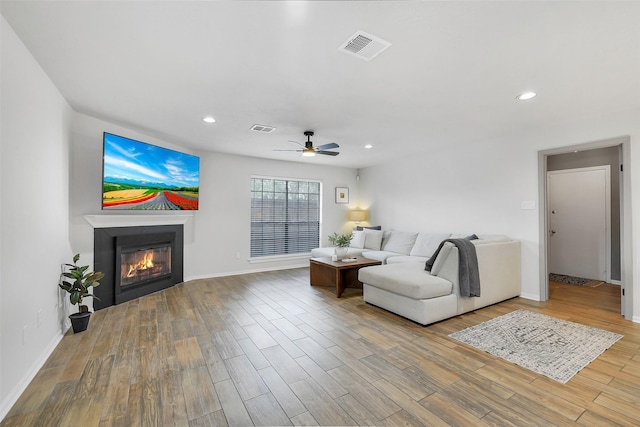 16202 Elm Point Ct, Houston, TX 77095 - living area with ceiling fan, a glass covered fireplace, wood finished floors, recessed lighting, and baseboards