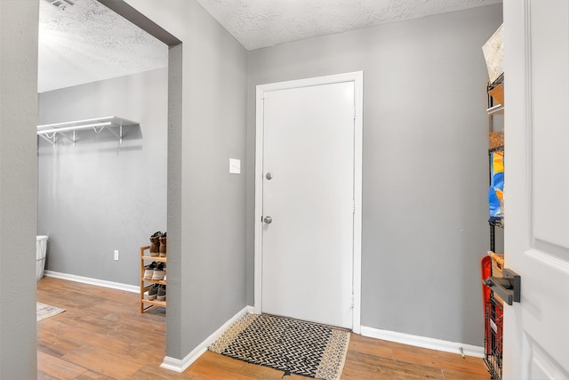 16202 Elm Point Ct, Houston, TX 77095 - entrance foyer featuring wood finished floors, a textured ceiling, and baseboards