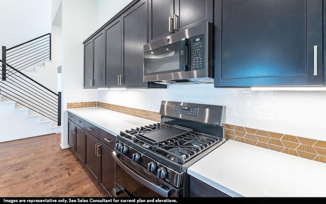 422 Riesling Dr, Alvin, TX 77511 - kitchen featuring stainless steel appliances, light countertops, wood finished floors, and tasteful backsplash