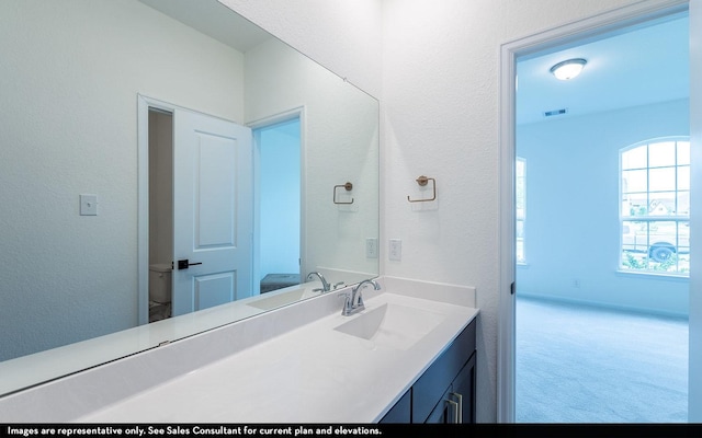 422 Riesling Dr, Alvin, TX 77511 - bathroom with vanity, a textured wall, and toilet