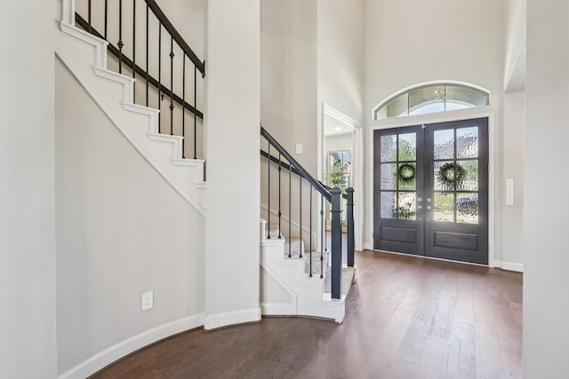 28814 Creekside Bend Dr, Fulshear, TX 77441 - entrance foyer featuring french doors, wood finished floors, a towering ceiling, stairs, and baseboards