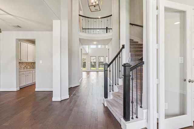 28814 Creekside Bend Dr, Fulshear, TX 77441 - entrance foyer with dark wood finished floors, stairway, baseboards, and a chandelier