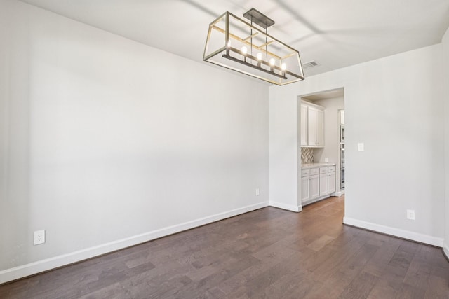 28814 Creekside Bend Dr, Fulshear, TX 77441 - unfurnished room featuring a chandelier, dark wood-style flooring, and baseboards