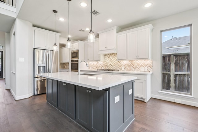 28814 Creekside Bend Dr, Fulshear, TX 77441 - kitchen with a sink, appliances with stainless steel finishes, white cabinetry, tasteful backsplash, and recessed lighting