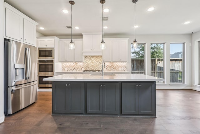 28814 Creekside Bend Dr, Fulshear, TX 77441 - kitchen with appliances with stainless steel finishes, a sink, white cabinets, light countertops, and recessed lighting