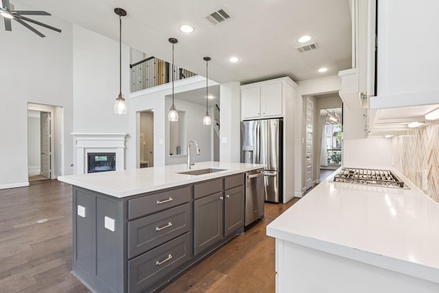 28814 Creekside Bend Dr, Fulshear, TX 77441 - kitchen featuring a sink, appliances with stainless steel finishes, gray cabinetry, white cabinets, and light countertops