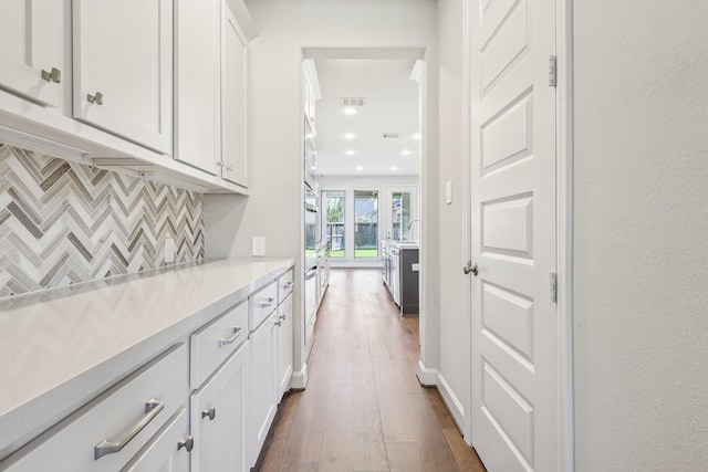 28814 Creekside Bend Dr, Fulshear, TX 77441 - bar with dark wood finished floors, tasteful backsplash, and stainless steel oven