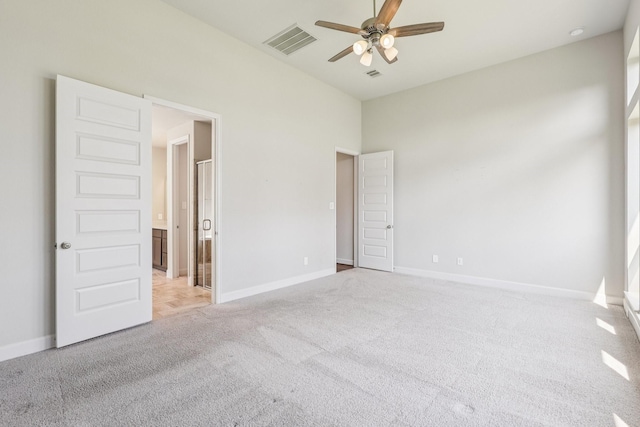 28814 Creekside Bend Dr, Fulshear, TX 77441 - unfurnished bedroom featuring light carpet, baseboards, a ceiling fan, and ensuite bathroom
