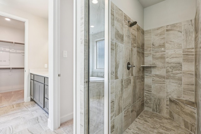 28814 Creekside Bend Dr, Fulshear, TX 77441 - bathroom with a stall shower, vanity, a spacious closet, and recessed lighting