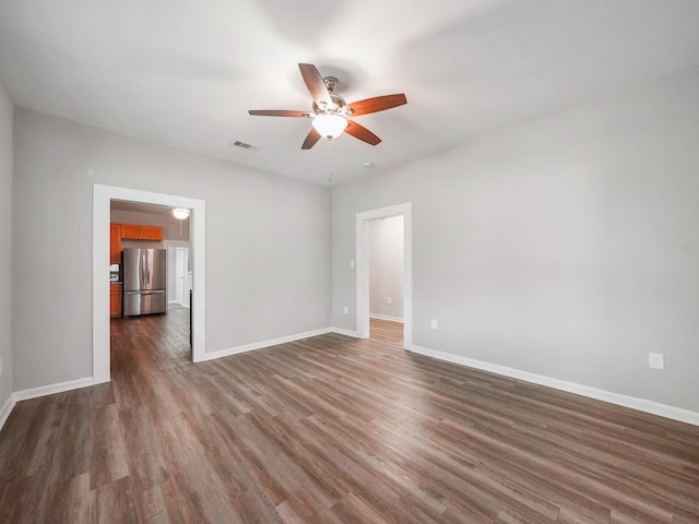 2402 49th St, Galveston, TX 77551 - unfurnished room featuring a ceiling fan, dark wood-type flooring, and baseboards