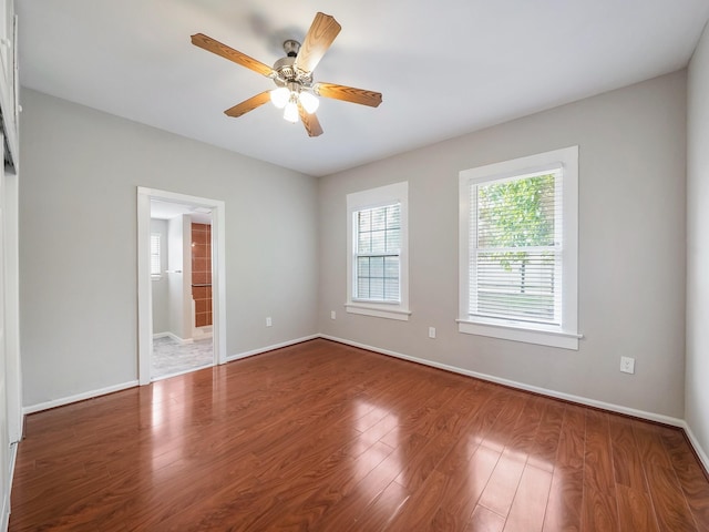 2402 49th St, Galveston, TX 77551 - spare room with wood finished floors, ceiling fan, and baseboards