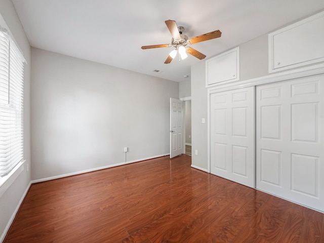 2402 49th St, Galveston, TX 77551 - unfurnished bedroom featuring wood finished floors, a closet, baseboards, and ceiling fan
