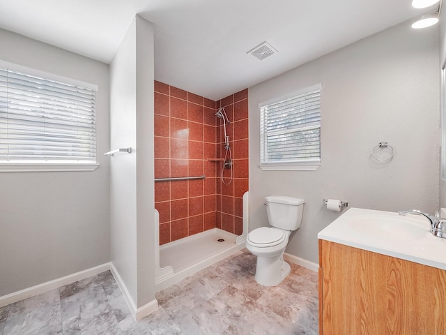 2402 49th St, Galveston, TX 77551 - full bath featuring toilet, vanity, tiled shower, and baseboards