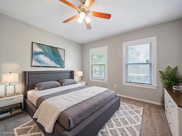 2402 49th St, Galveston, TX 77551 - bedroom featuring light colored carpet, baseboards, and ceiling fan