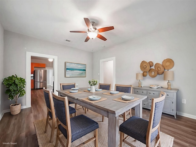 2402 49th St, Galveston, TX 77551 - dining room with ceiling fan, baseboards, and dark wood-type flooring