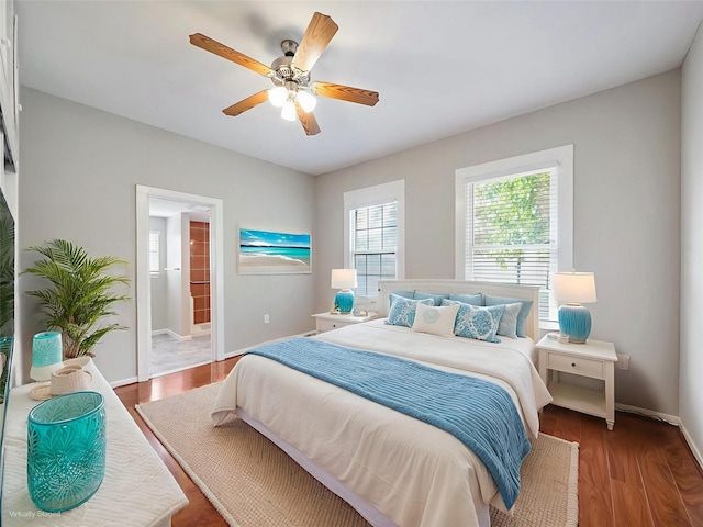 2402 49th St, Galveston, TX 77551 - bedroom with baseboards, wood finished floors, ceiling fan, and ensuite bath