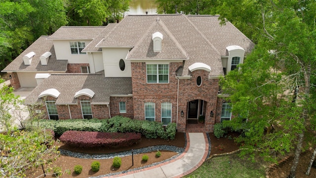 3806 W Benders Landing Blvd, Spring, TX 77386 - french country inspired facade with brick siding, stucco siding, and a shingled roof