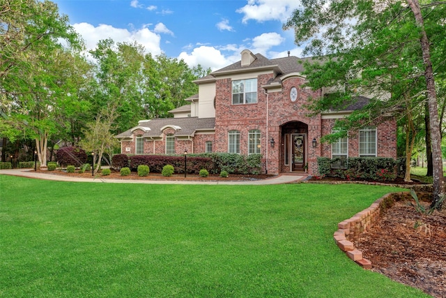 3806 W Benders Landing Blvd, Spring, TX 77386 - view of front of house with brick siding, a front lawn, and roof with shingles