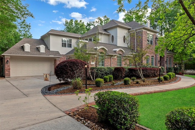 3806 W Benders Landing Blvd, Spring, TX 77386 - traditional-style home with brick siding, stucco siding, concrete driveway, and an attached garage