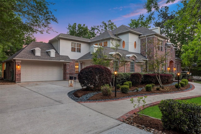 3806 W Benders Landing Blvd, Spring, TX 77386 - traditional home with stucco siding, driveway, an attached garage, and brick siding