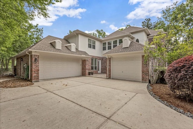 3806 W Benders Landing Blvd, Spring, TX 77386 - traditional-style house with an attached garage, concrete driveway, brick siding, a shingled roof, and stucco siding